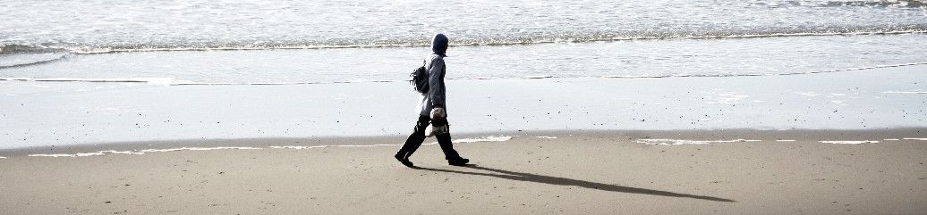 man walking on the seashore